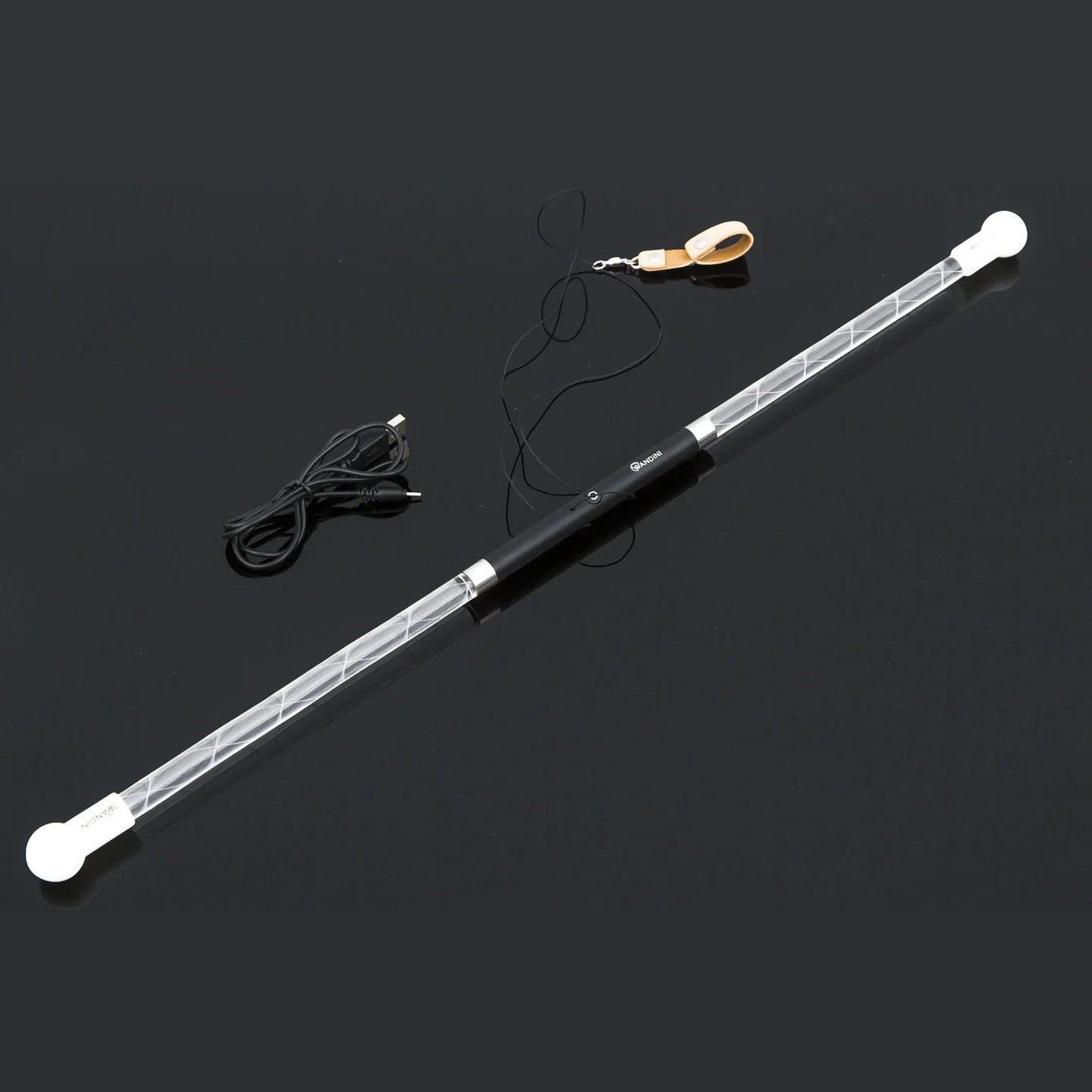 Long cylindrical light fixture with white ends and black body on a dark background