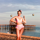 Model spinning poi on the beach 