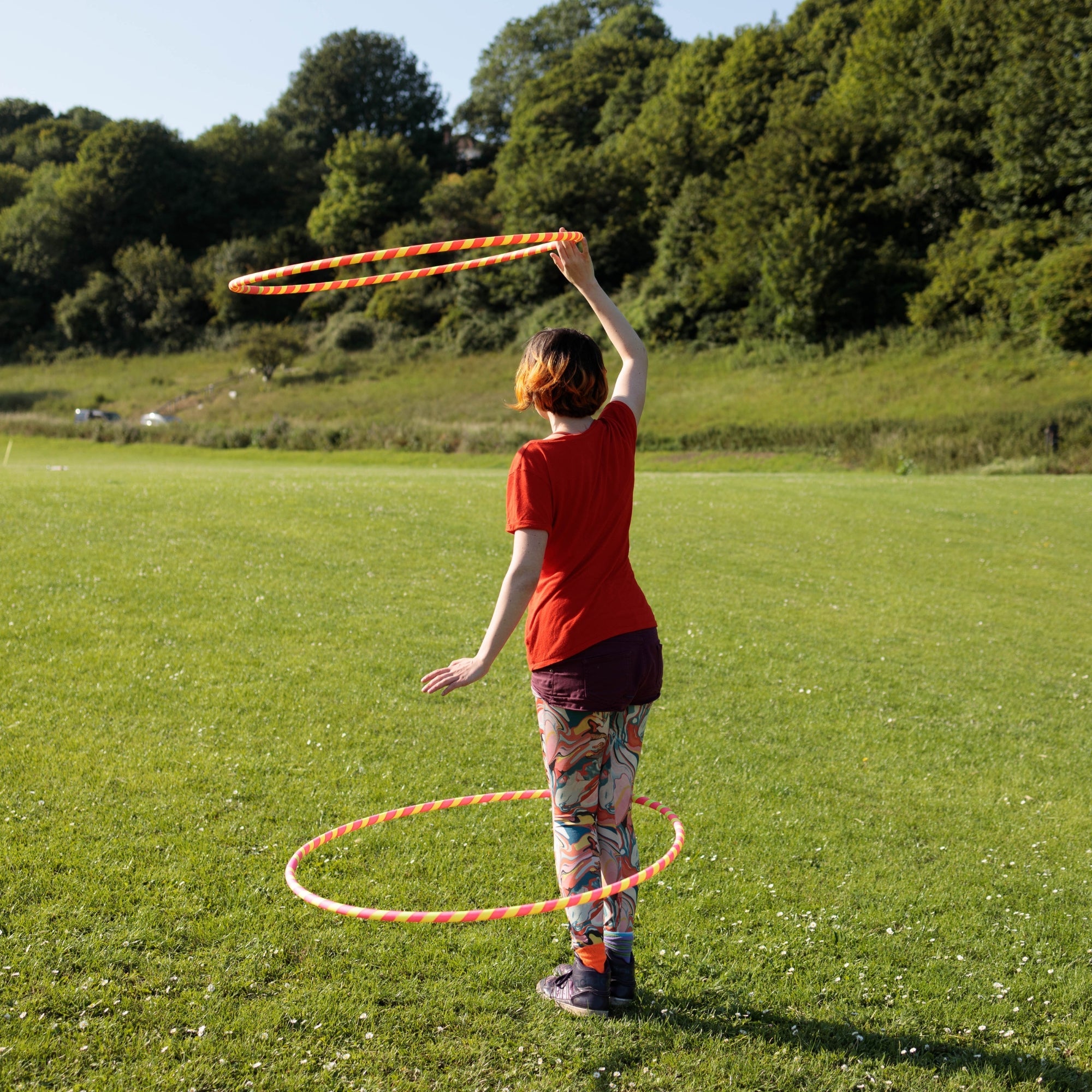 person spinning two hoops