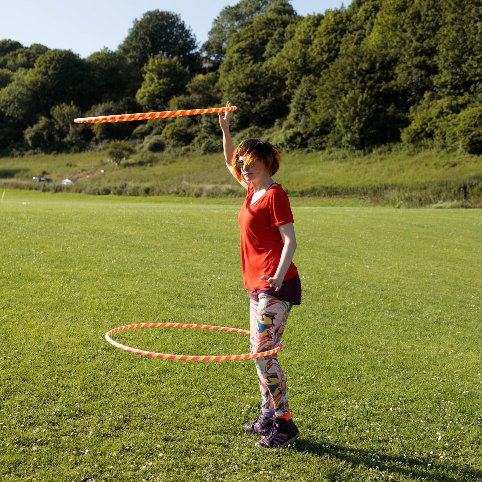 person spinning two hoops