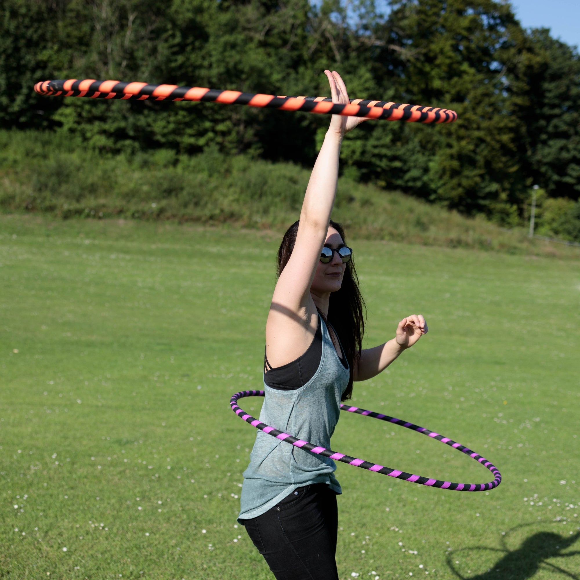 person spinning two hoops