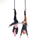 performers on extended trapeze