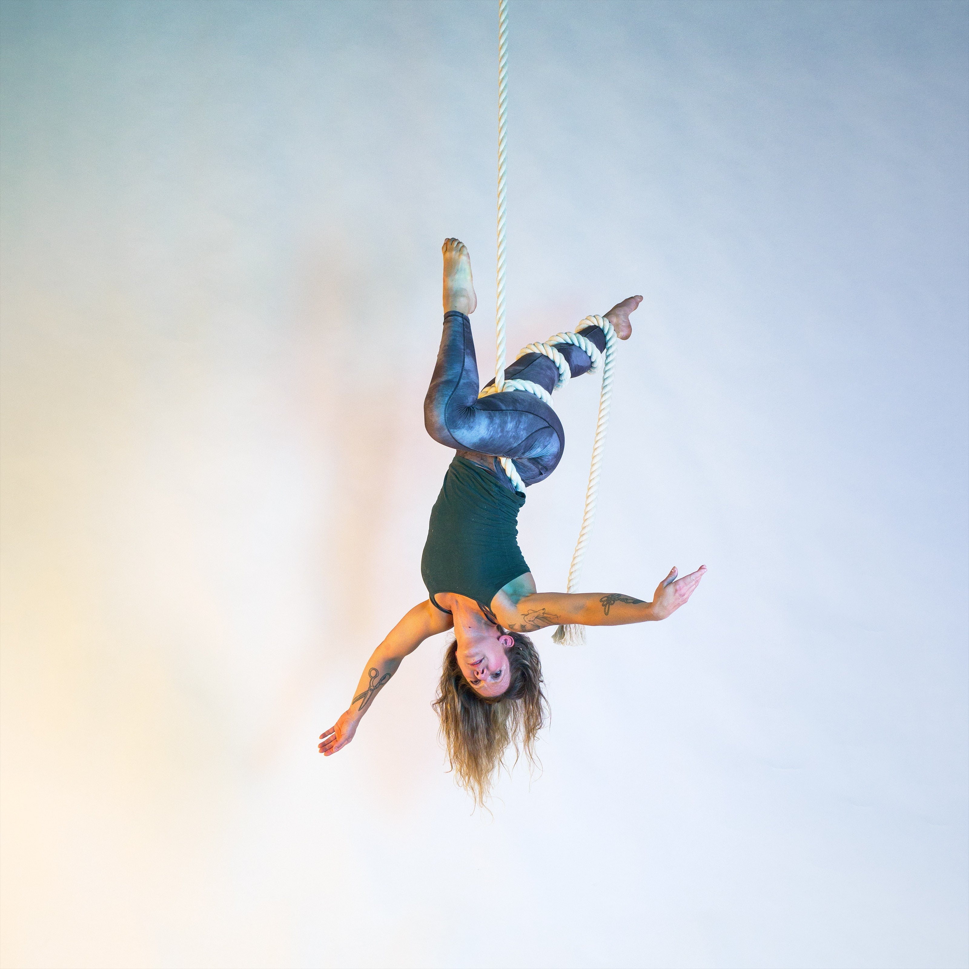 image of a performer on a white rope in a wrap known as isle of mann